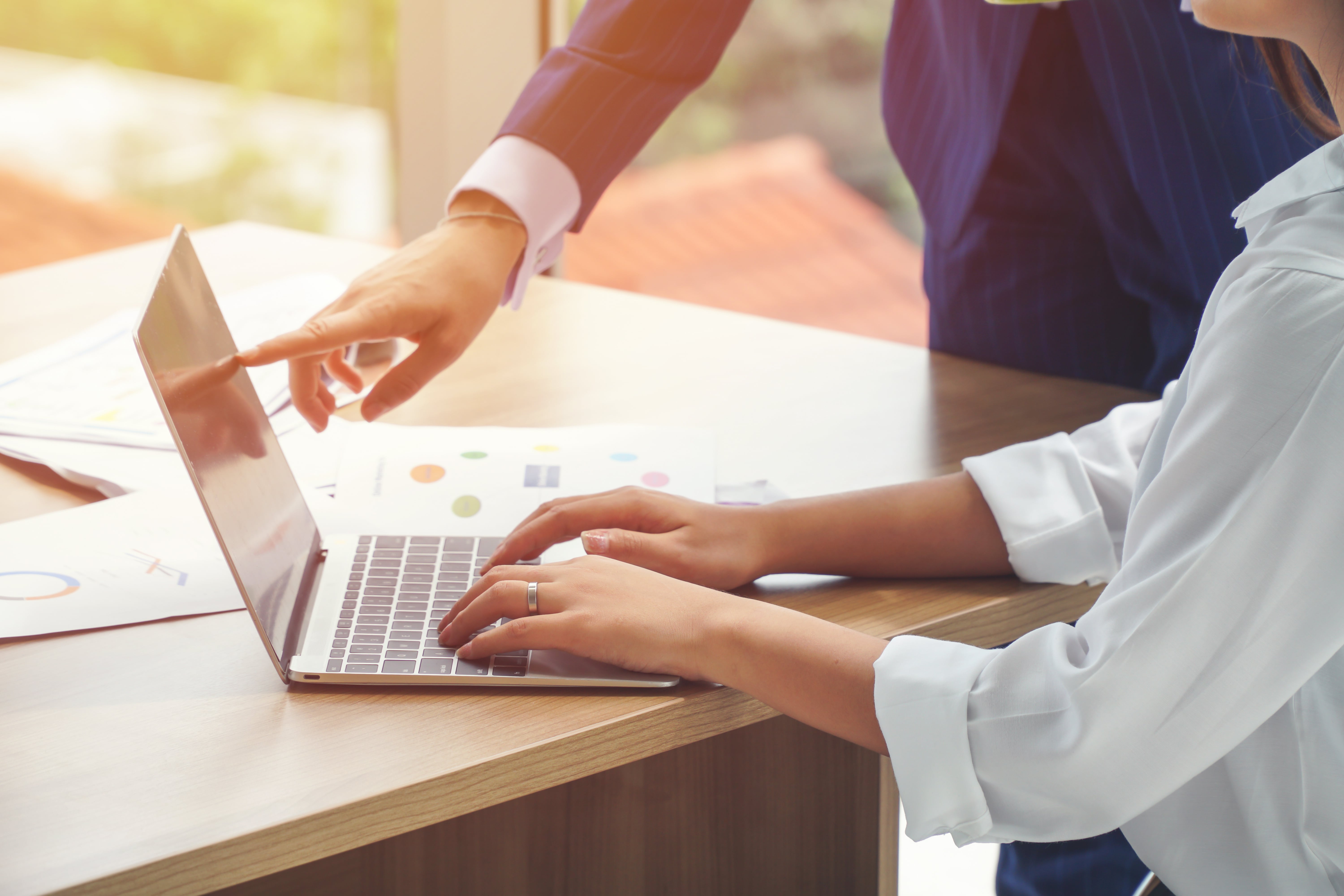 Business Woman Pointing at Laptop