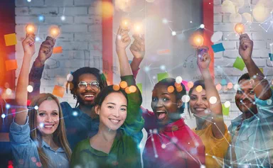 A team of different people holding lightbulbs in their hands.