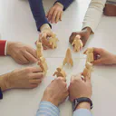A lightbulb representing an idea surrounded by a network in the form of a brain.